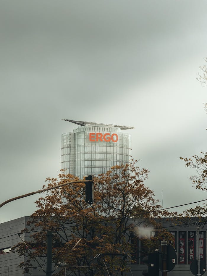 ERGO building in an urban fall landscape, featuring modern architecture and cloudy skies.