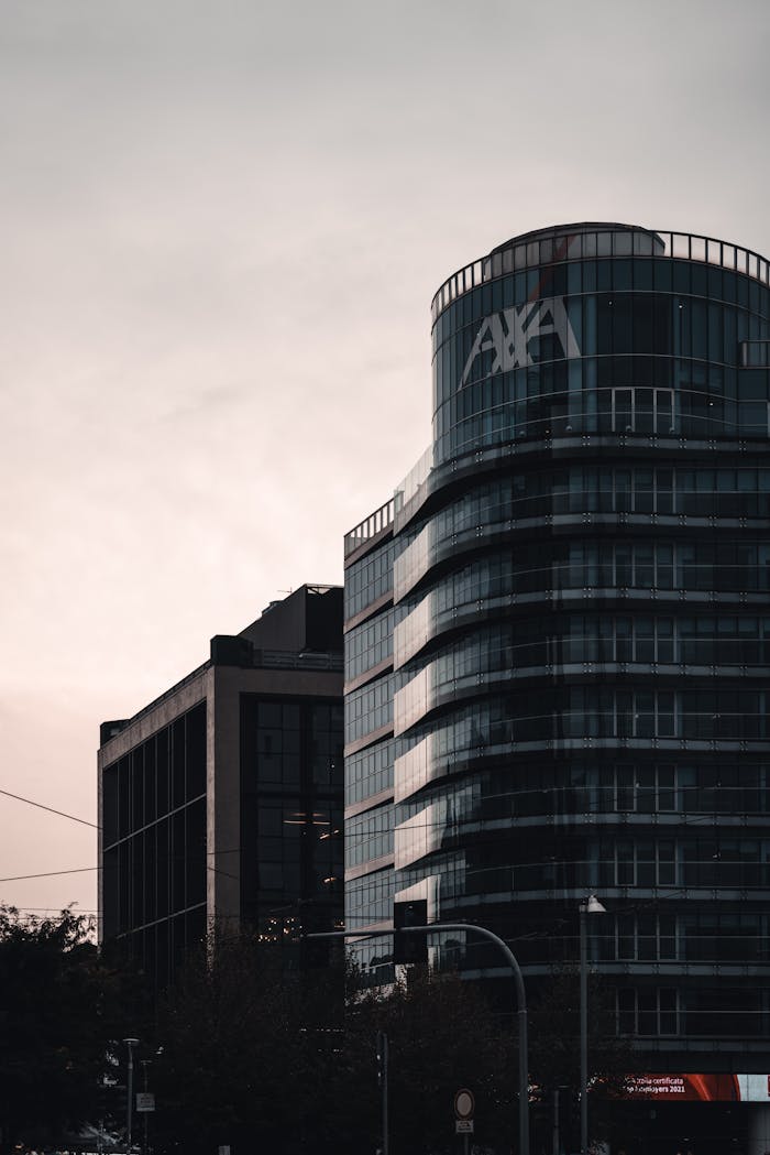 Services Urban cityscape showcasing modern office buildings with AXA signage at dusk, conveying a professional and corporate environment.